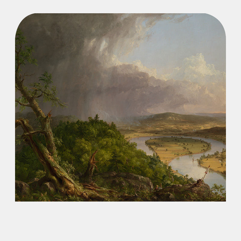 A landscape of a mountain looking over a flat land and river below.